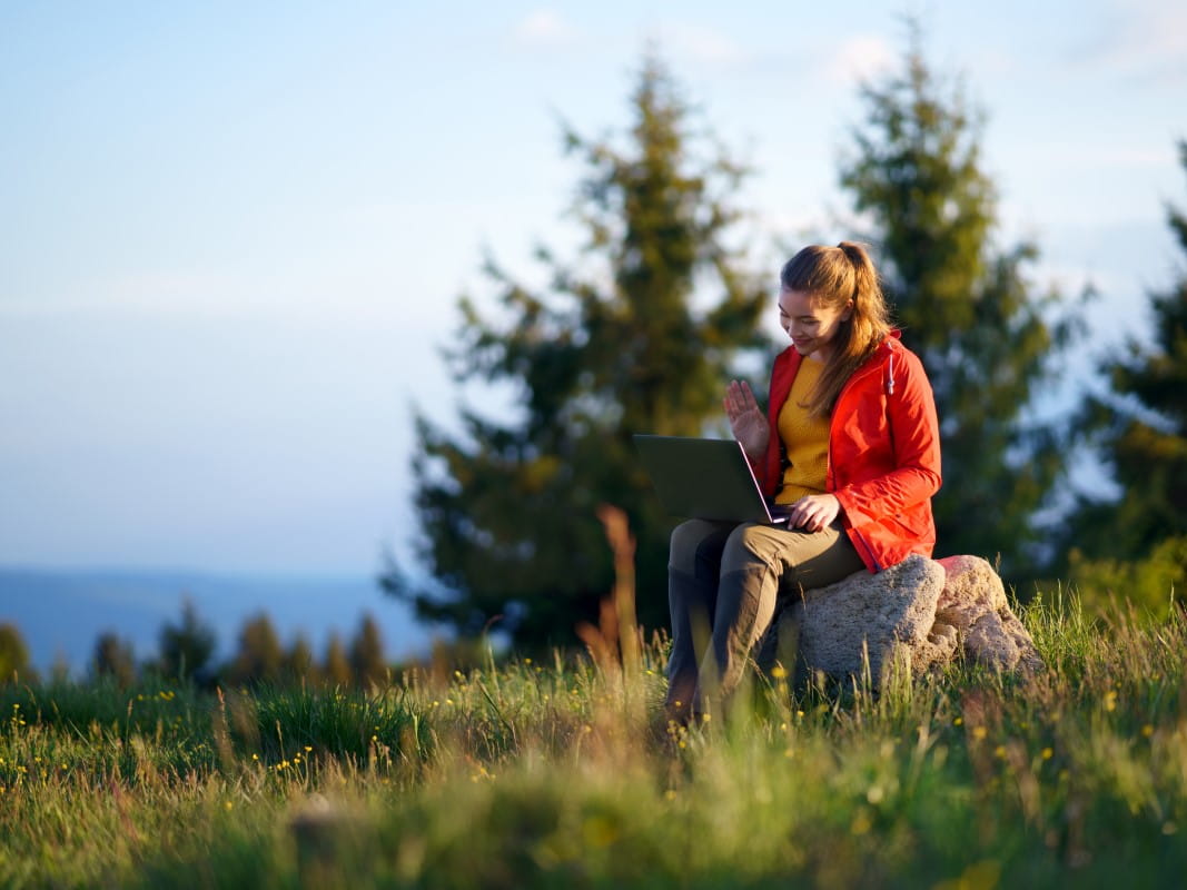 Woman on laptop in a field