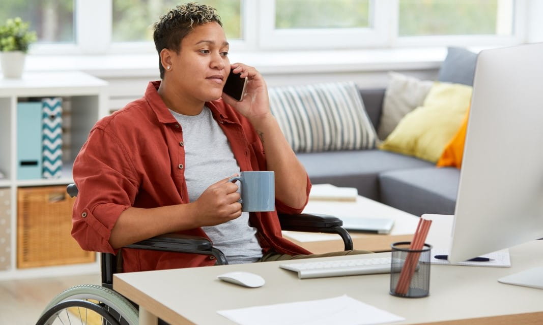Woman in wheelchair working from home