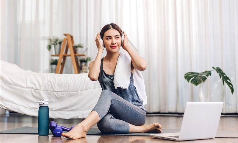 Woman sat on floor working on laptop