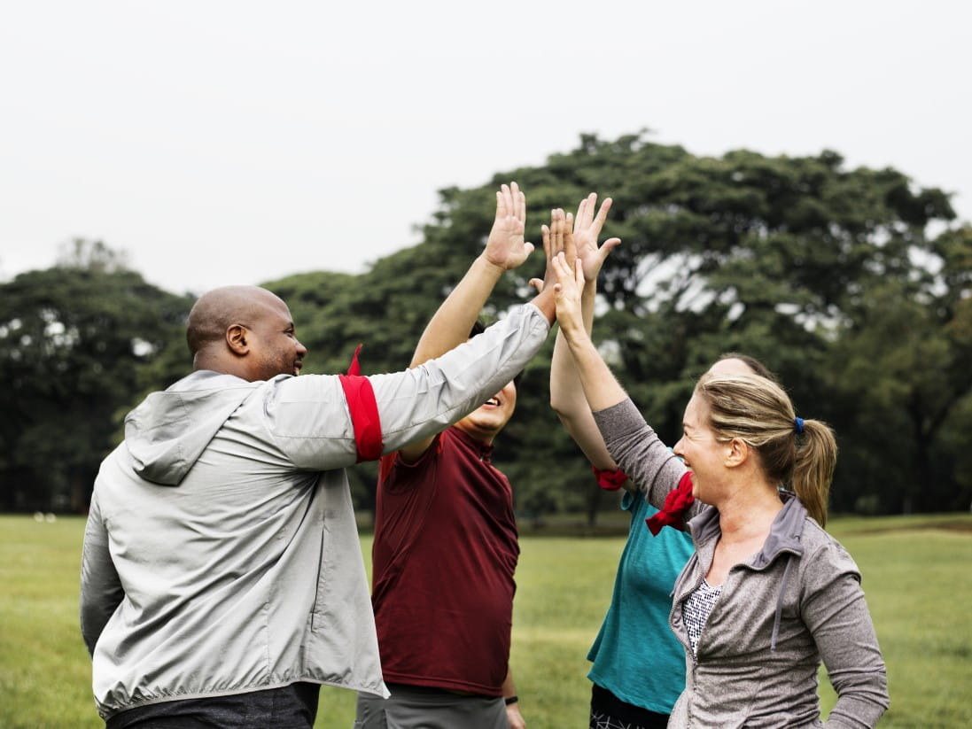 Team hi-fiving outside