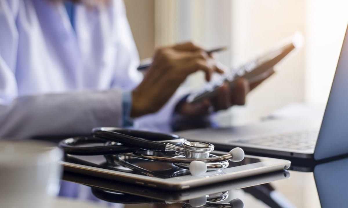 Doctor using calculator