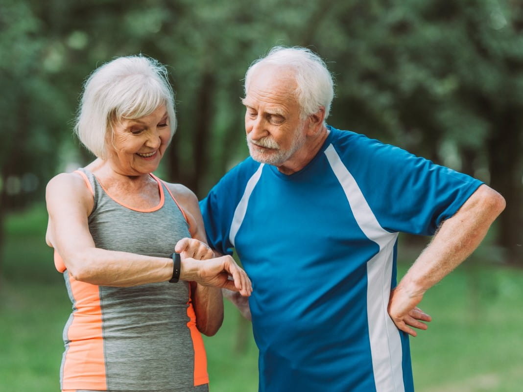 Elderly couple looking at tracker