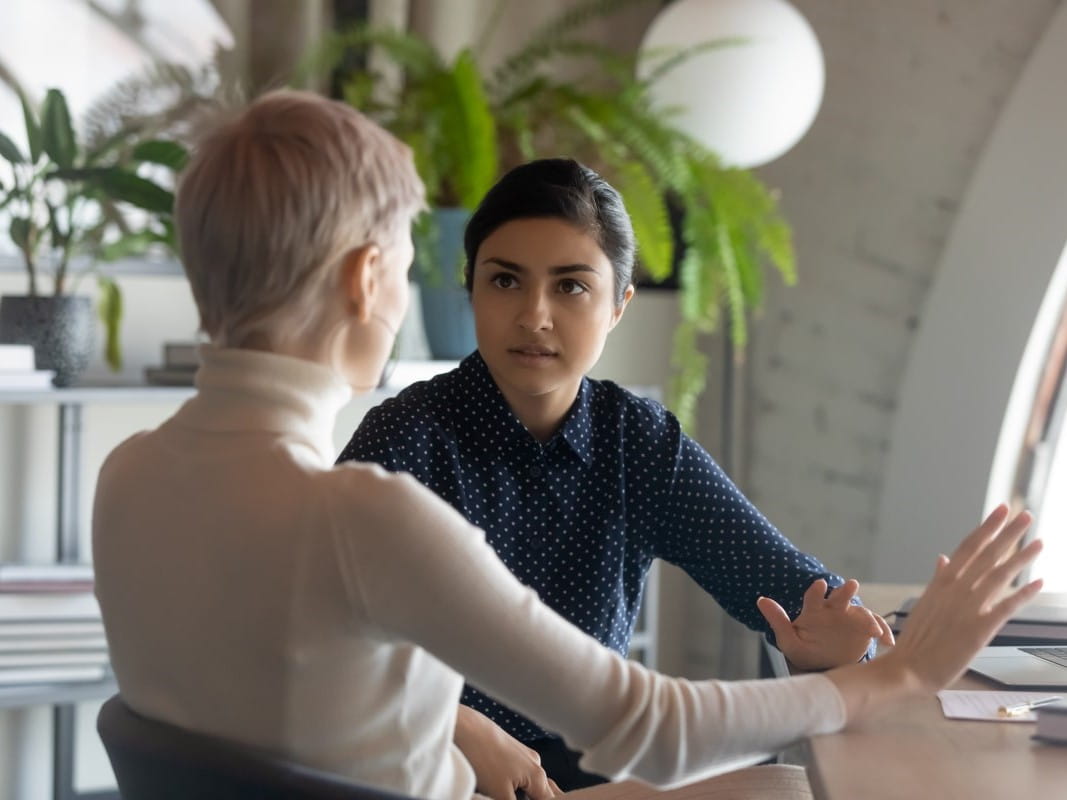 Two women mid-conversation