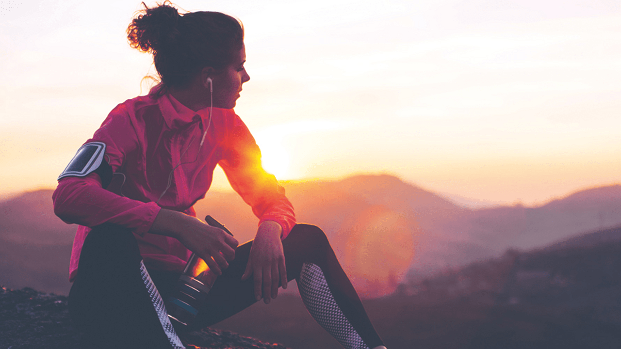 Woman sat watching sunrise