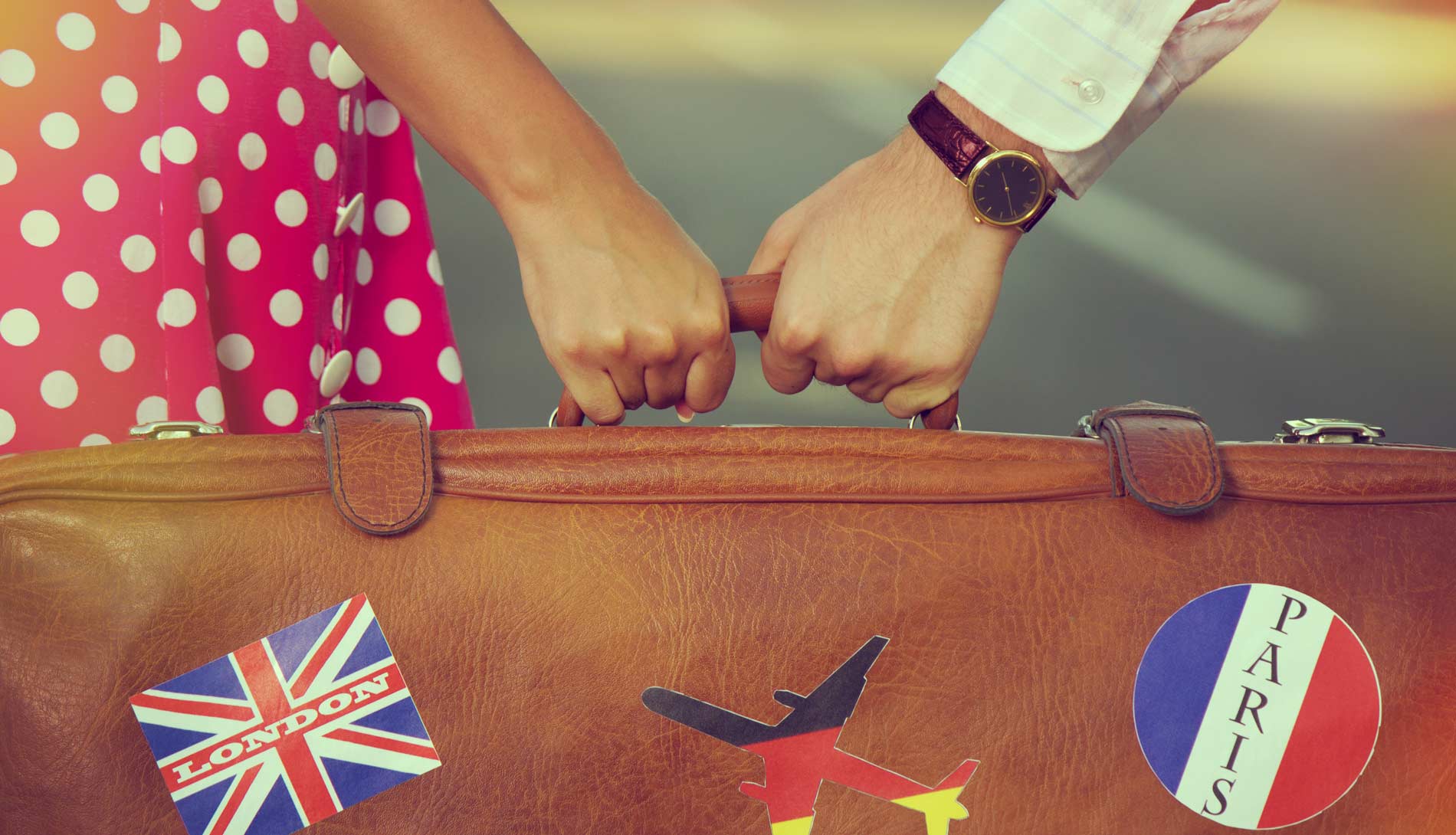 Couple holding suitcase