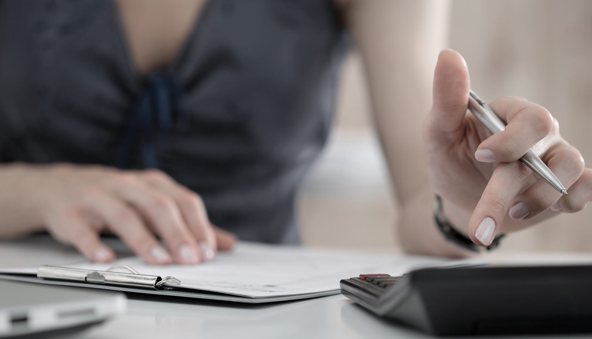Close-up of female using calculator