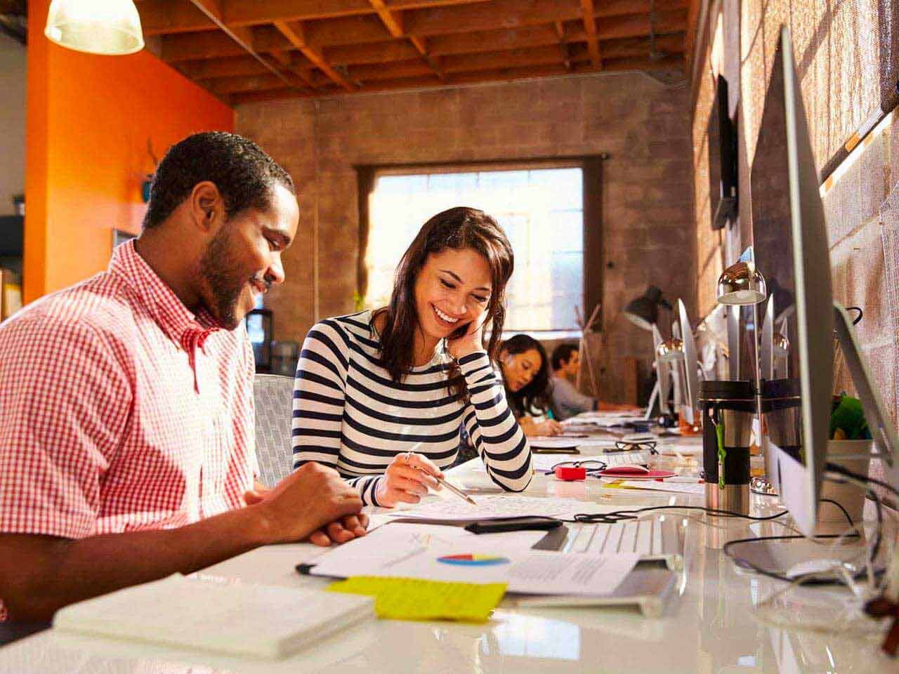 Man and woman sat at desk working