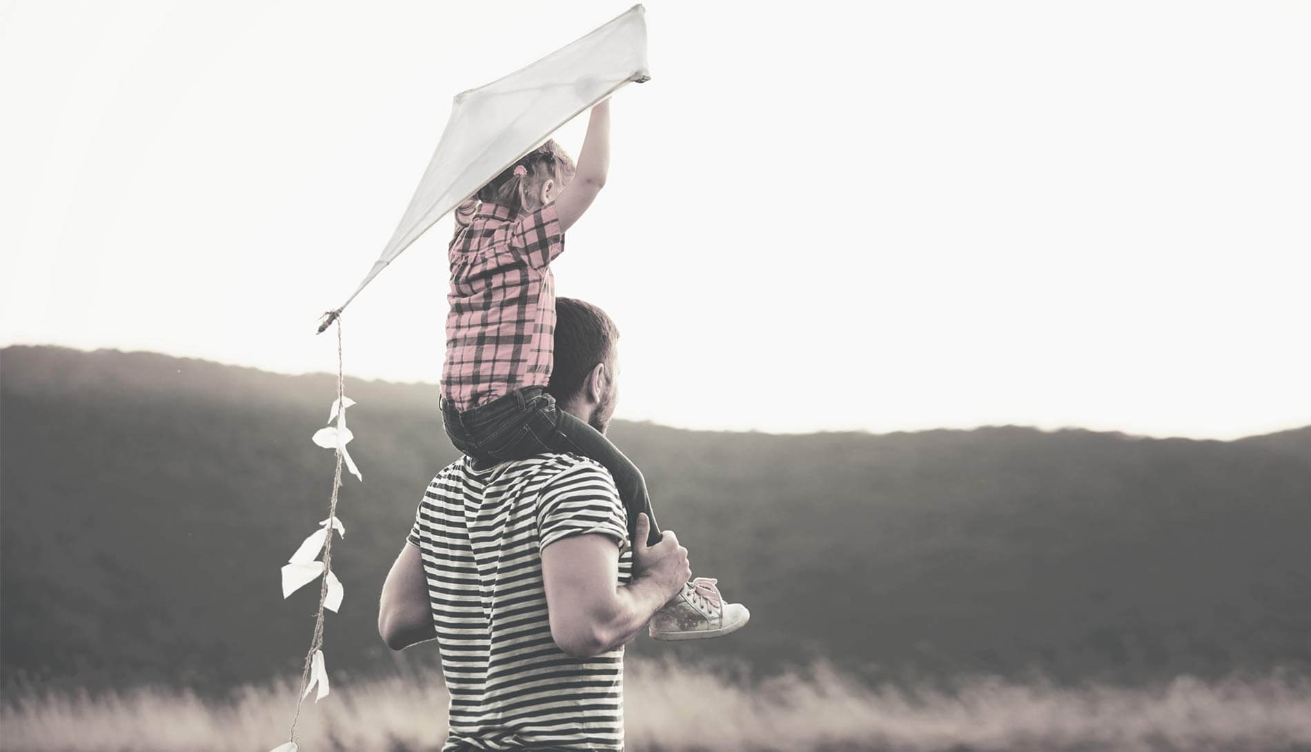 Dad and child flying a kite