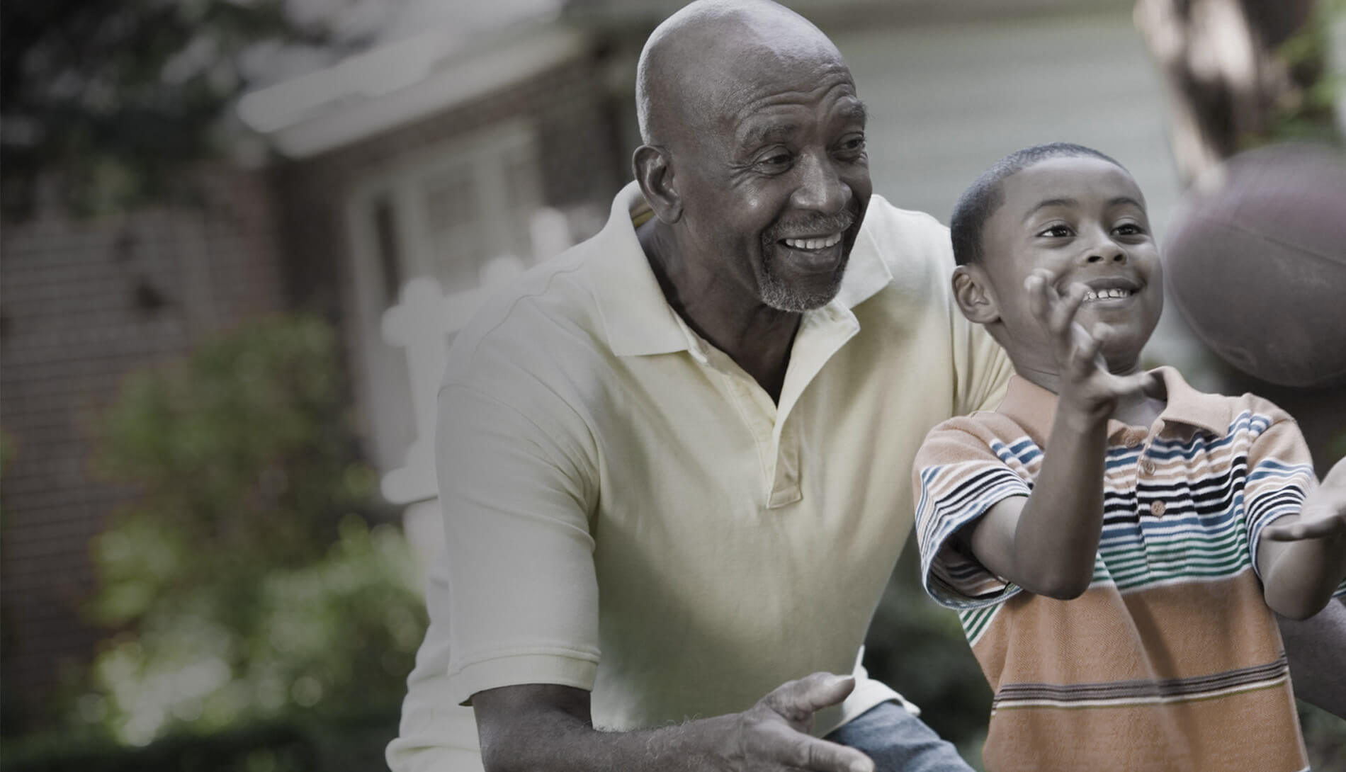 Man and boy playing basketball