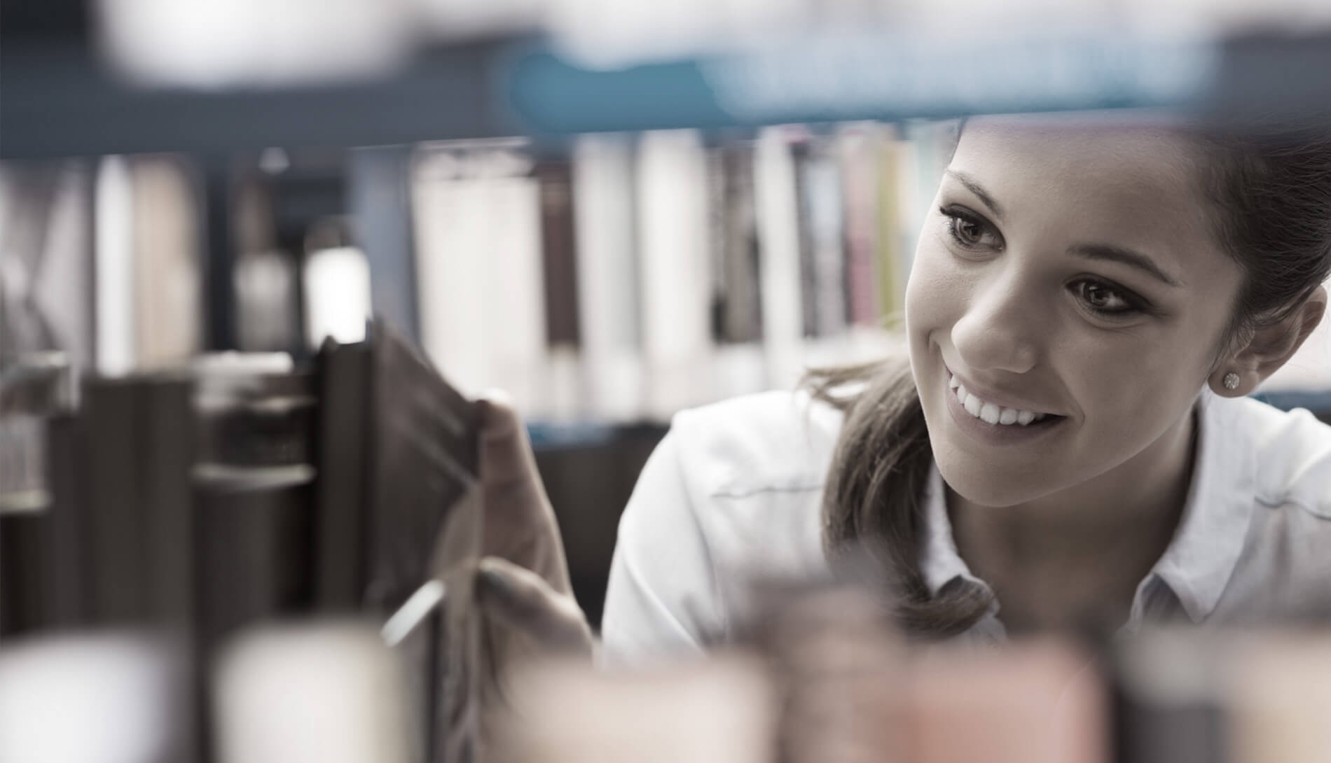 Woman using library shelf
