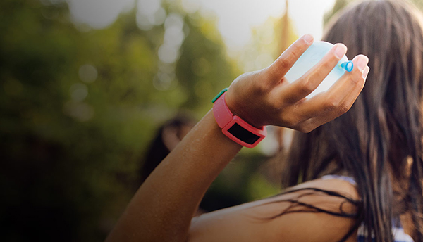 Decorative image of a woman wearing a Fitbit