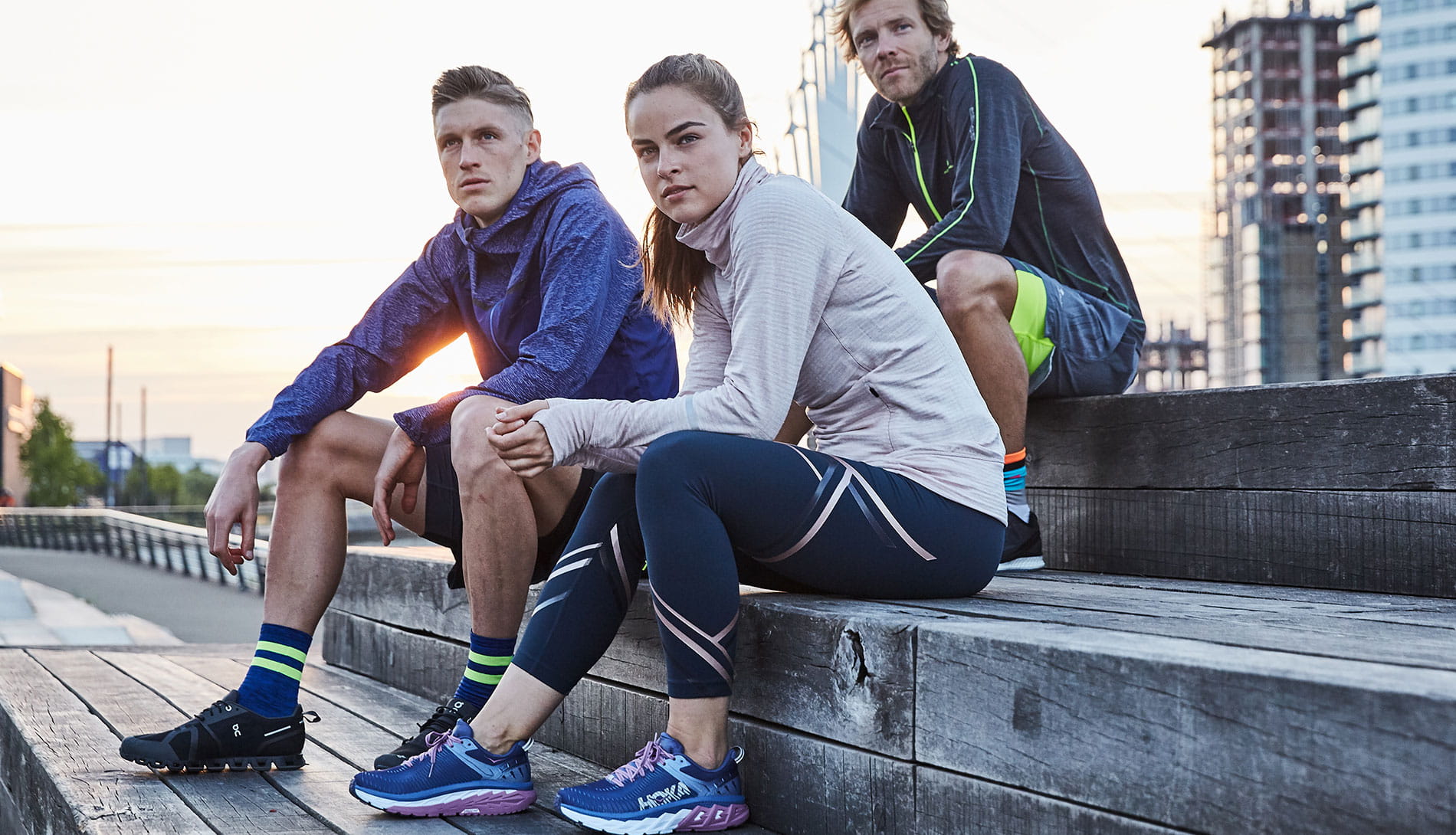 Runners Need members sitting on steps